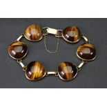 A 9ct gold and tigers' eye-set bangle of link design,