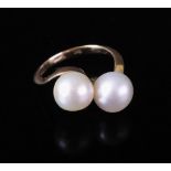 An 18ct gold and cultured pearl dress ring of cross-over design,