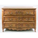 A Louis XV provincial oak commode, of panelled construction,