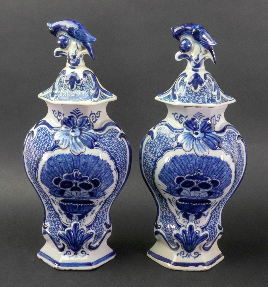A pair of Dutch Delft blue and white hexagonal baluster vases and covers, late 18th century,