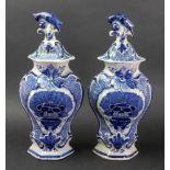 A pair of Dutch Delft blue and white hexagonal baluster vases and covers, late 18th century,