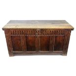 A late 17th century oak coffer, of panelled construction, the hinged top with gouged ends,
