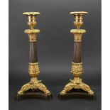 A pair of Empire bronze gilt metal mounted candlesticks,