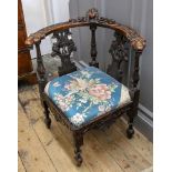 A late 17th century style foliate carved walnut corner chair, 19th century,