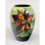 A Moorcroft Dahlia pattern ovoid vase, decoarated against a green/blue ground, 13.5cm high.