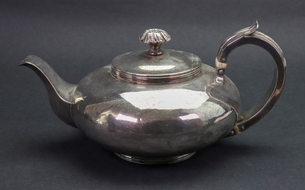 A George IV silver compressed circular teapot, London 1825, makers mark M S, with threaded rim,