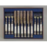 A set of six pairs of Victorian electroplate fruit knives and forks,