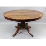 A Regency rosewood brass strung and foliate cut-brass centre table, the circular tilt-top,