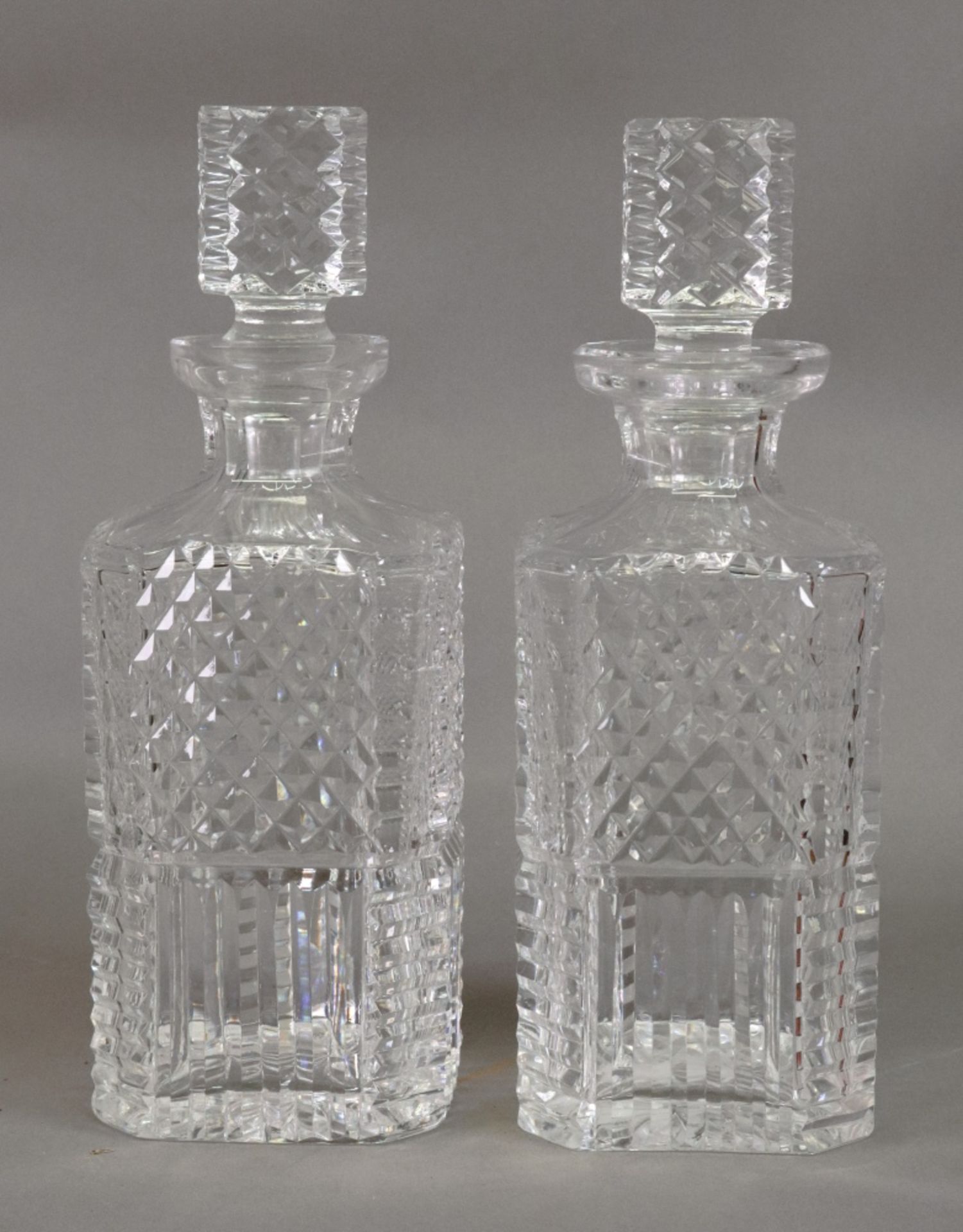 A pair of Waterford square section cut glass decanters, 25cm high.