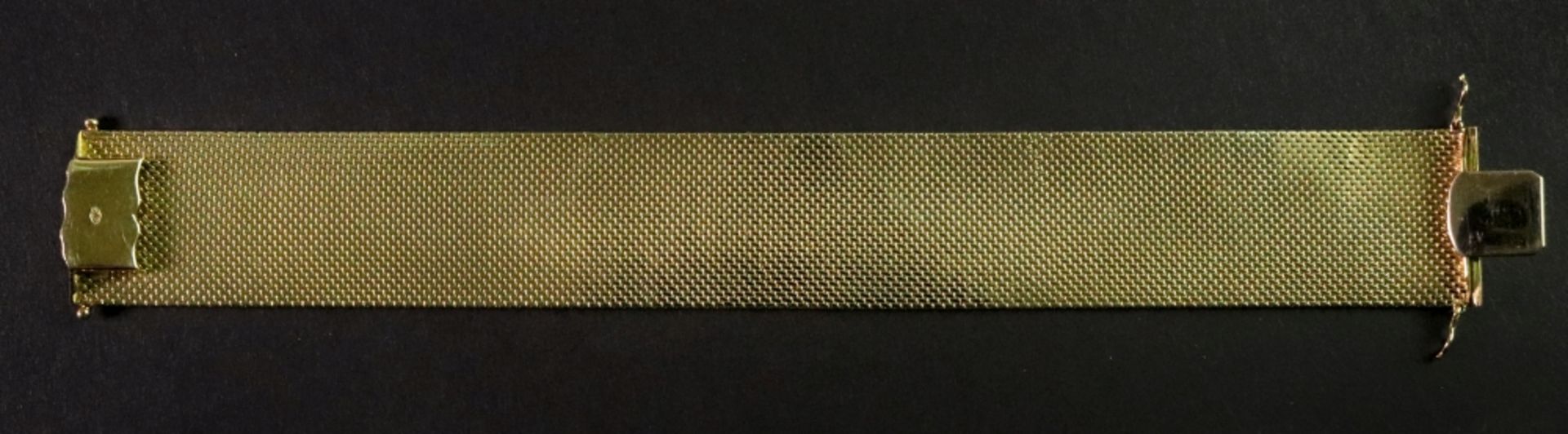 A 14ct gold fancy-link bracelet designed as a wide textured strap,