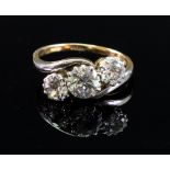 An 18ct gold three-stone diamond cross-over ring,