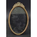 An oval French gilt metal easel photograph frame, late 19th century,