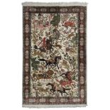 An Indian silk rug, depicting a hunting scene on a cream ground,