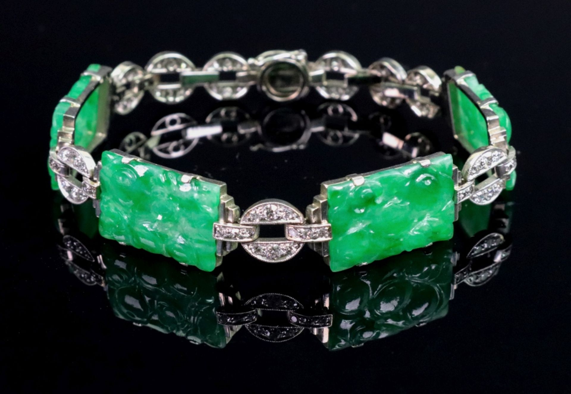 A jadeite and diamond-set bracelet, composed of four carved rectangular jadeite plaques,