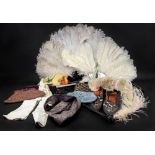 An ostrich feather fan with mother of pearl sticks and guard, another in faux tortoiseshell,