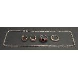 A silver and garnet three-stone ring, ring size L, a 9ct white gold and diamond ring, ring size K,