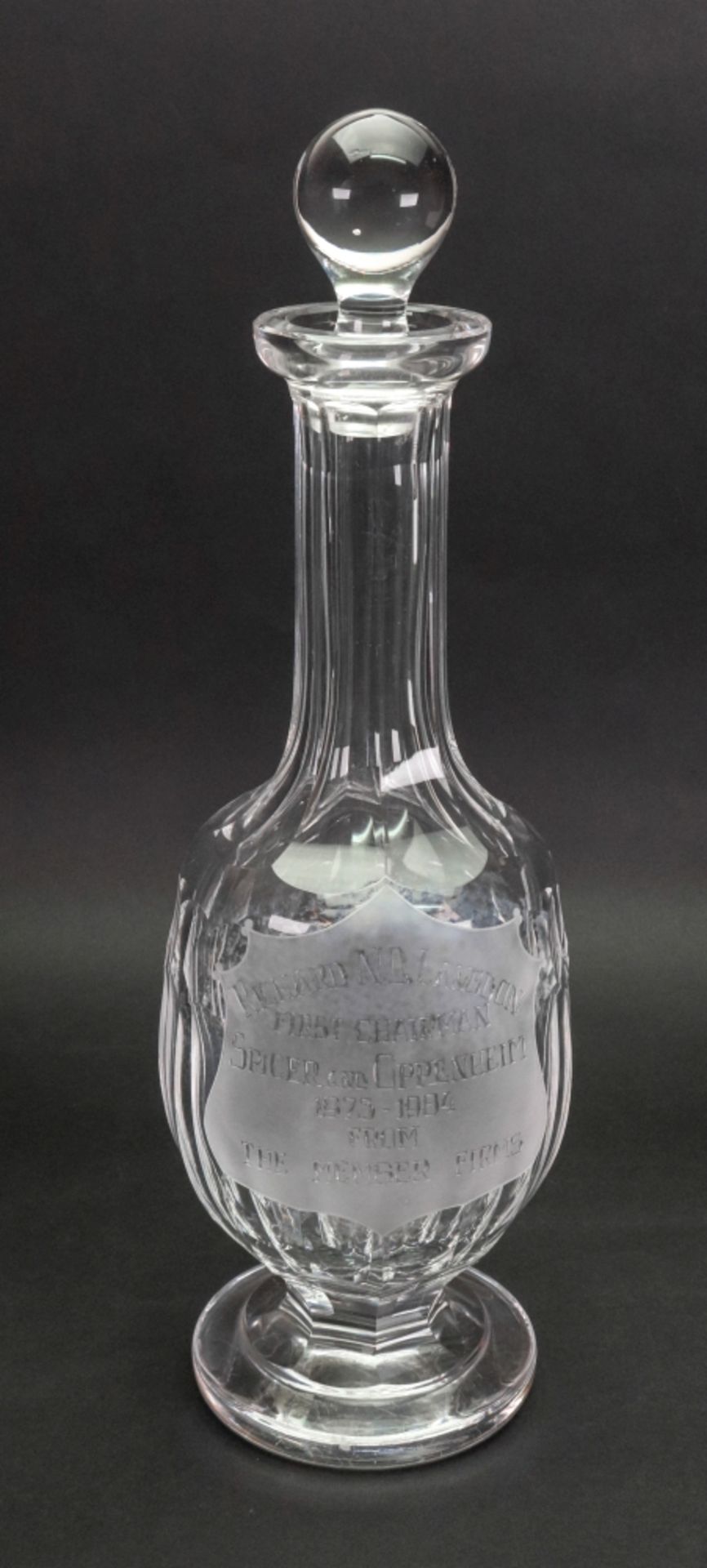 A Waterford facet cut glass decanter, inscribed with a presentation inscription '...