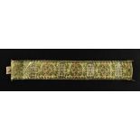 A 14ct tri-gold fancy-link bracelet designed as a wide textured strap,