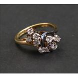 An 18ct gold and diamond-set dress ring, the eleven single-cut stones in a stepped claw setting,