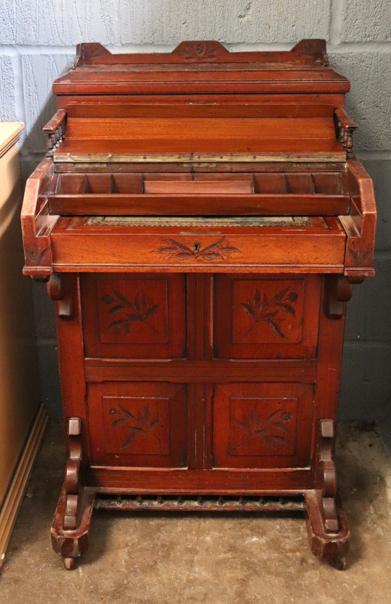 A late Victorian foliate carved walnut piano front davenport, of panelled construction, - Image 2 of 3