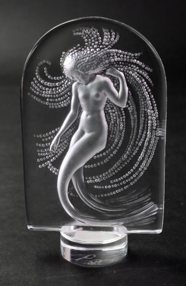 A Lalique crystal mermaid paperweight, etched Lalique France, 10cm high. Illustrated.