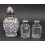 An Edwardian silver mounted diamond cut glass baluster shape perfume bottle, John Grinsell & Sons,
