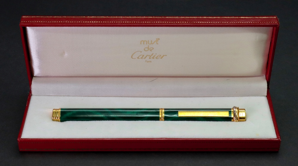 Must de Cartier Paris; a gold plated and green lacquer faux marble ball point pen, in fitted case.