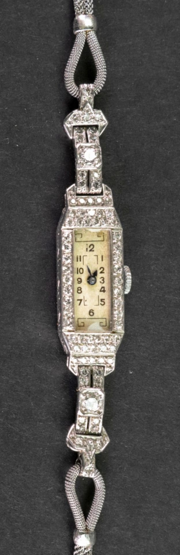 A diamond set cocktail watch of canted rectangular design, the dial with Arabic numerals,