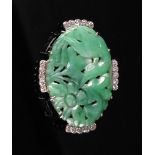 A pierced and carved jadeite and diamond-set brooch of oval shape,