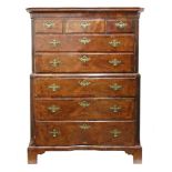 A George I walnut cross and feather banded tallboy chest, reduced in height,