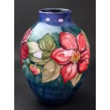 A Moorcroft Clematis pattern baluster vase, decorated against a blue/green ground, 27cm high.