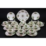 A New Chelsea tea service, retailed by Thomas Goode & Co, painted with roses, 12 each tea cups,
