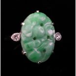 A pierced and carved jadeite and diamond-set plaque ring of oval shape,