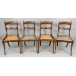 A set of four Regency beech stained as mahogany dining chairs, with gadrooned top rails,