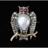 A late 19th/early 20th century diamond, pearl and ruby owl brooch, realistically formed,