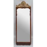 A tall early 18th century walnut frame upright wall mirror,