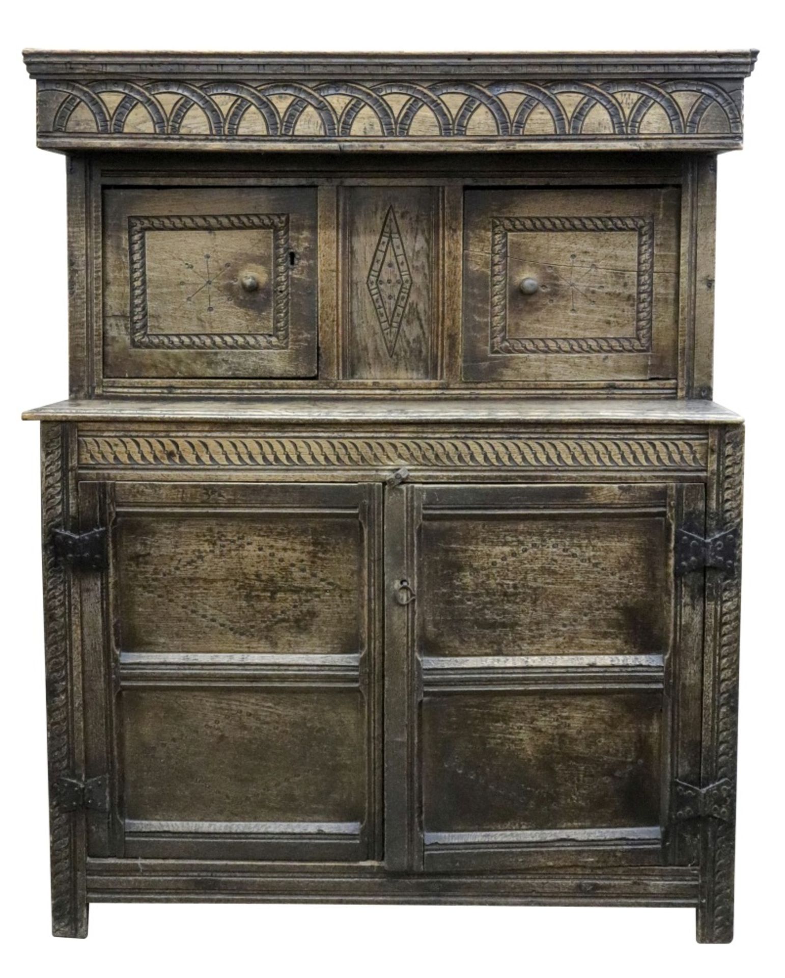 A Jacobean carved oak court cupboard, of panelled construction,