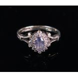 A 9ct gold, sapphire and diamond ring of cluster design, with an oval-cut sapphire,