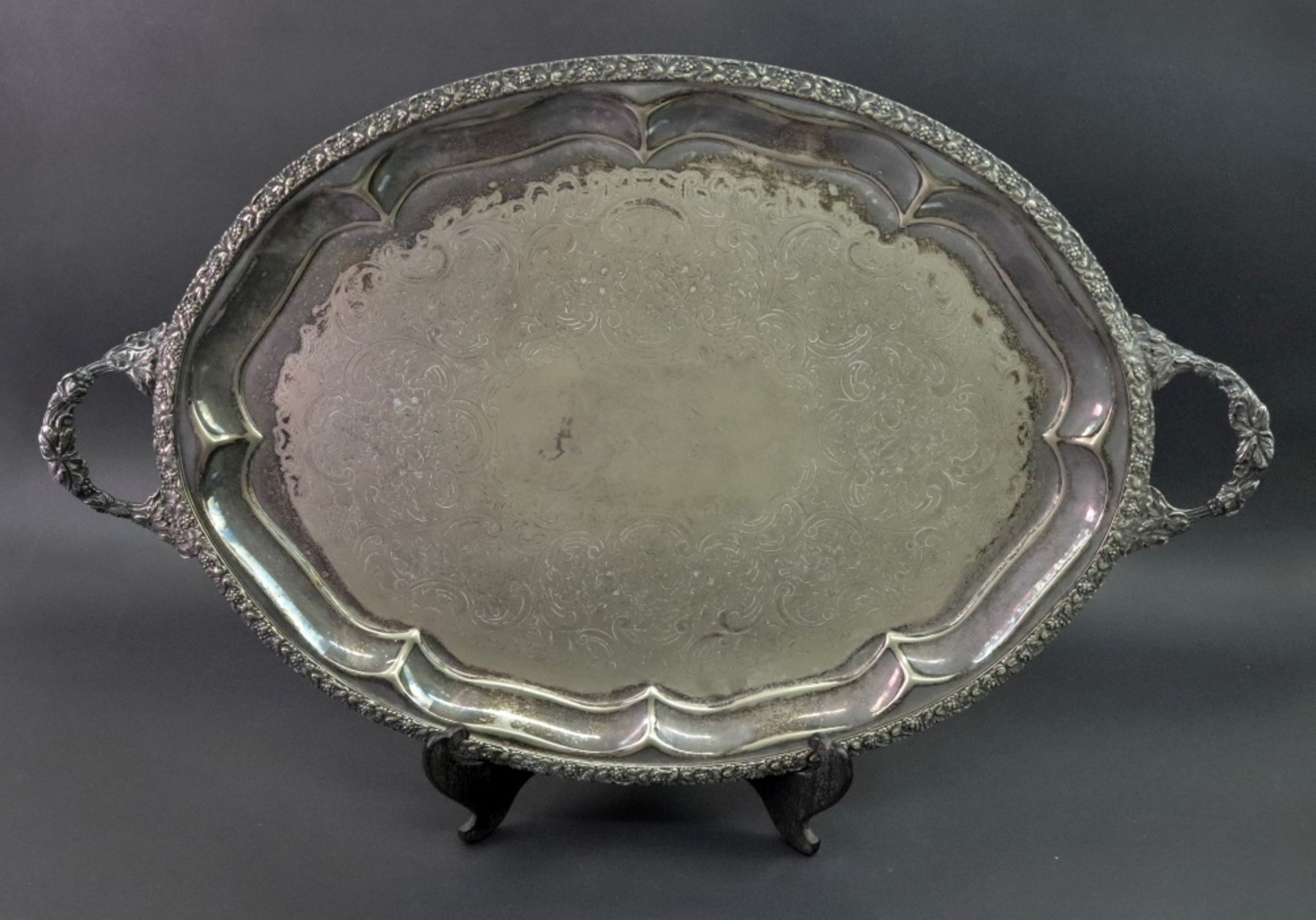 A George IV style oval two handled electroplate tray, with fruiting vine cast border and handles,
