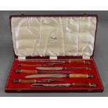 A seven piece horn handled carving knife set, Harrods, with electroplate ferrules and capitals,