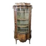 A Louis XV style rosewood gilt metal mounted vitrine, late 19th century, of shaped outline,