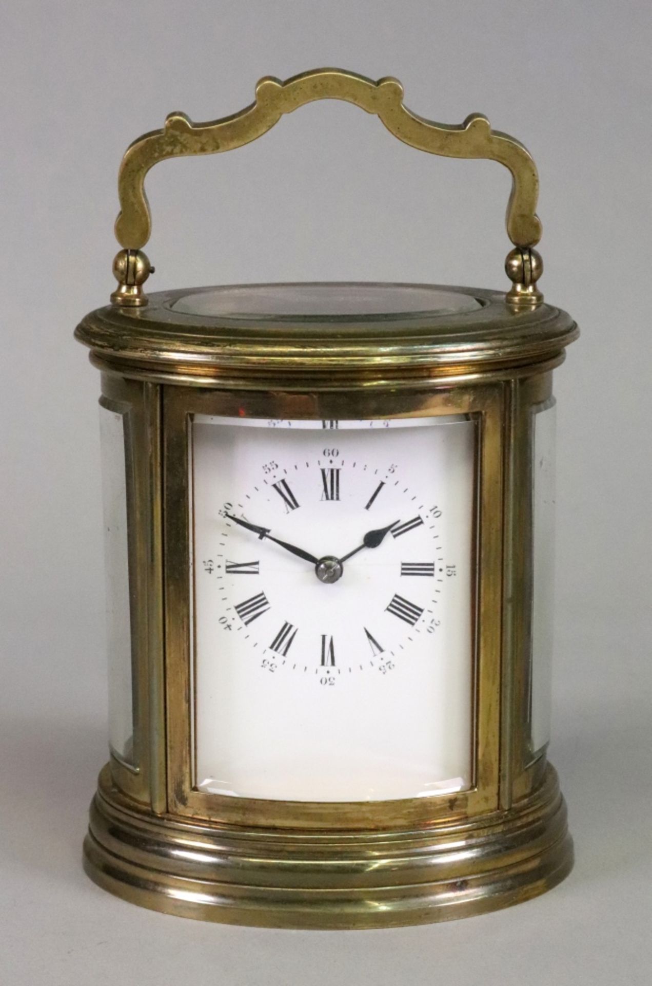 An oval brass cased carriage clock, 20th century,