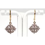 A pair of diamond-set pendant earrings in a stylised geometric floral design,