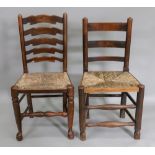 A set of four George III style ash and elm wavy ladder back dining chairs, with rush seats,