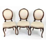 A set of three Louis XVI style foliate carved walnut frame salon chairs, second half 19th century,