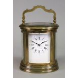 An oval brass cased carriage clock, 20th