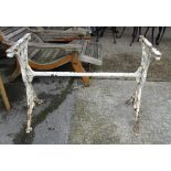 A late Victorian white painted cast iron table base, top lacking, 99cm wide x 69cm high.