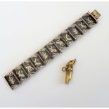 A Siamese niello decorated bracelet, in a curved panel shaped link design, on a snap clasp,