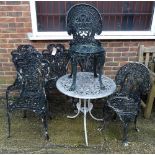 A set of four black painted metal garden chairs, with a matching oval metal garden table,