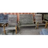 Garden furniture; a bench 135cm wide and a pair of matching armchairs, 76cm wide x 98cm high, (3).